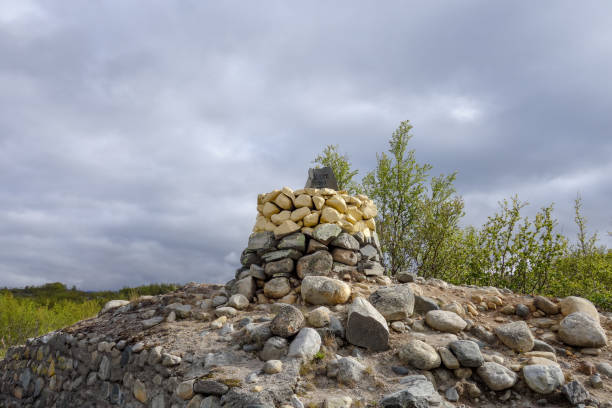 Border crossing between Finland and Norway north of Kilpisjärvi with a stone marked 1950 on a sunny day